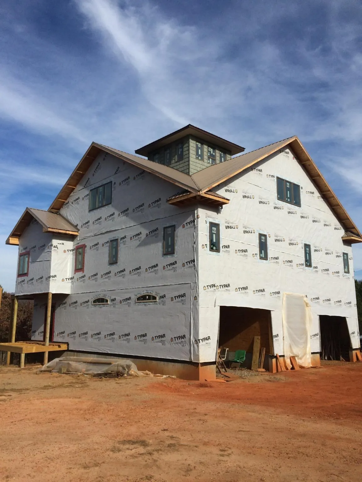 New two story house under construction with a cupola and gabled roofs in Wilmot
